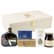 Greek gift box with artisan olive oil, organic oregano, Kalamon olives, and sea salt flakes arranged beside a luxury wooden box