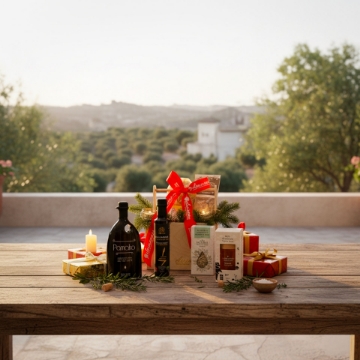 Experience the Taste of Crete with a Luxury Gourmet Food Hamper from Elenianna. Artisanal Greek food gift basket on a wooden table overlooking a serene Cretan landscape at sunset.