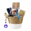A luxury Greek gift basket filled with gourmet foods like honey, ouzo, red pepper dip, and pasta, decorated with a blue evil eye charm.