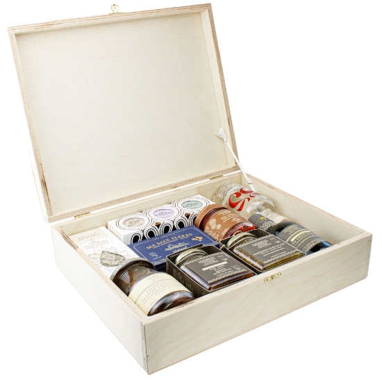 Open wooden gift box by Elenianna containing authentic Greek products: Navarino Icons extra virgin olive oil, Mouriki honey, Cretan Tsikoudia spirit, Kalamon olives, and gourmet preserves against a white background.