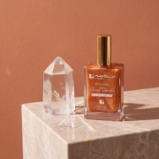 Mastic Spa Shimmering Dry Oil 100ml bottle with antioxidant Vitamin E and mastic gum on marble.